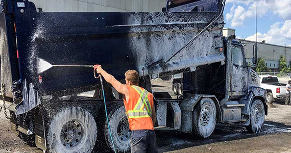 Technician Providing Truck Fleet Washing Services