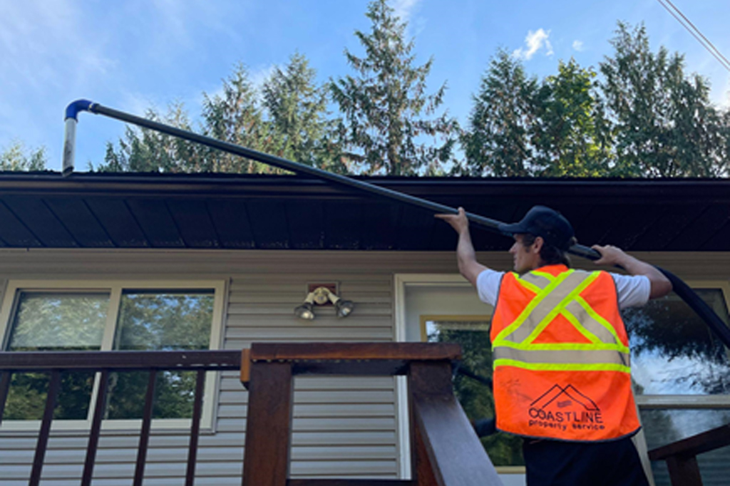 A professional performing gutter cleaning